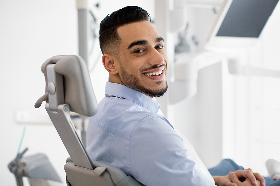Man smiling over his shoulder in a dentist's chair 