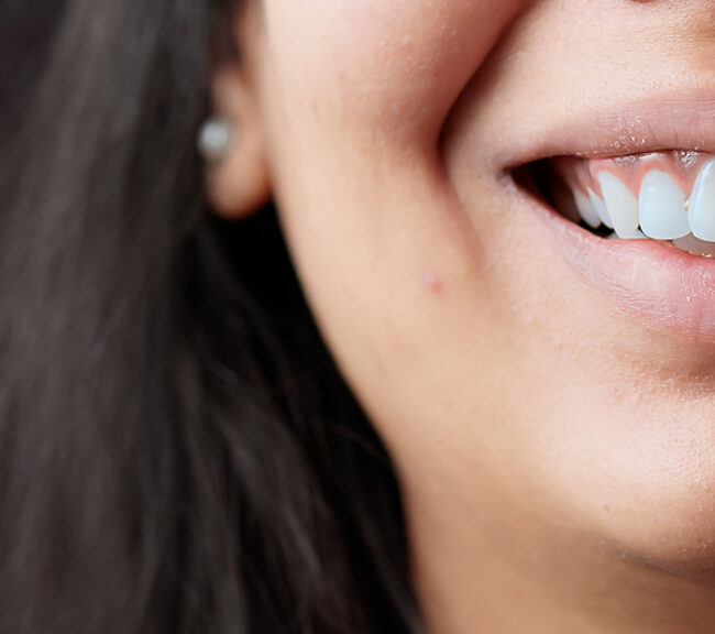Close up of a female with a white and authentic smile