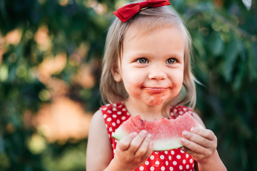 Cute child eats ripe juicy melon