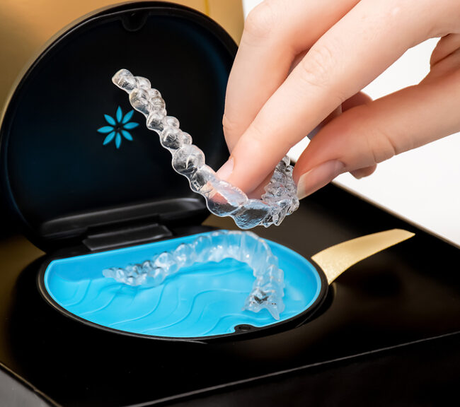 Invisalign aligners in a box. Invisible bracers. Clear teeth straighteners. Clear plastic bracers